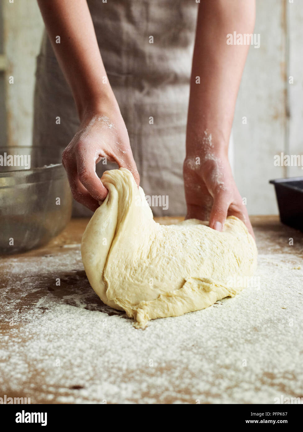 Kneading bread dough on floured surface Stock Photo