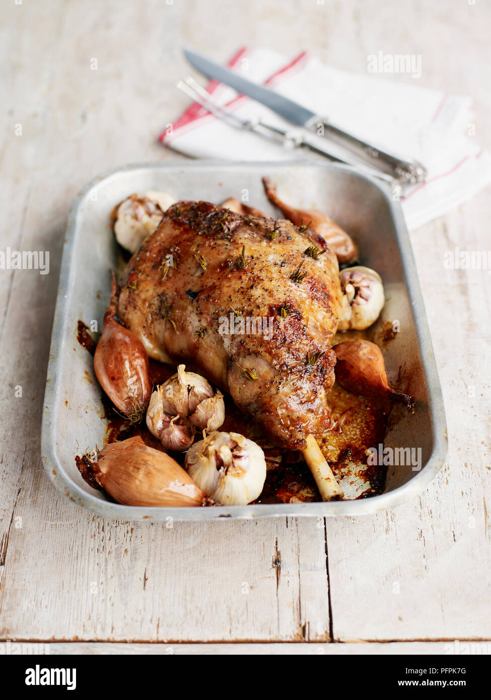 Roasted leg of lamb in roasting pan Stock Photo