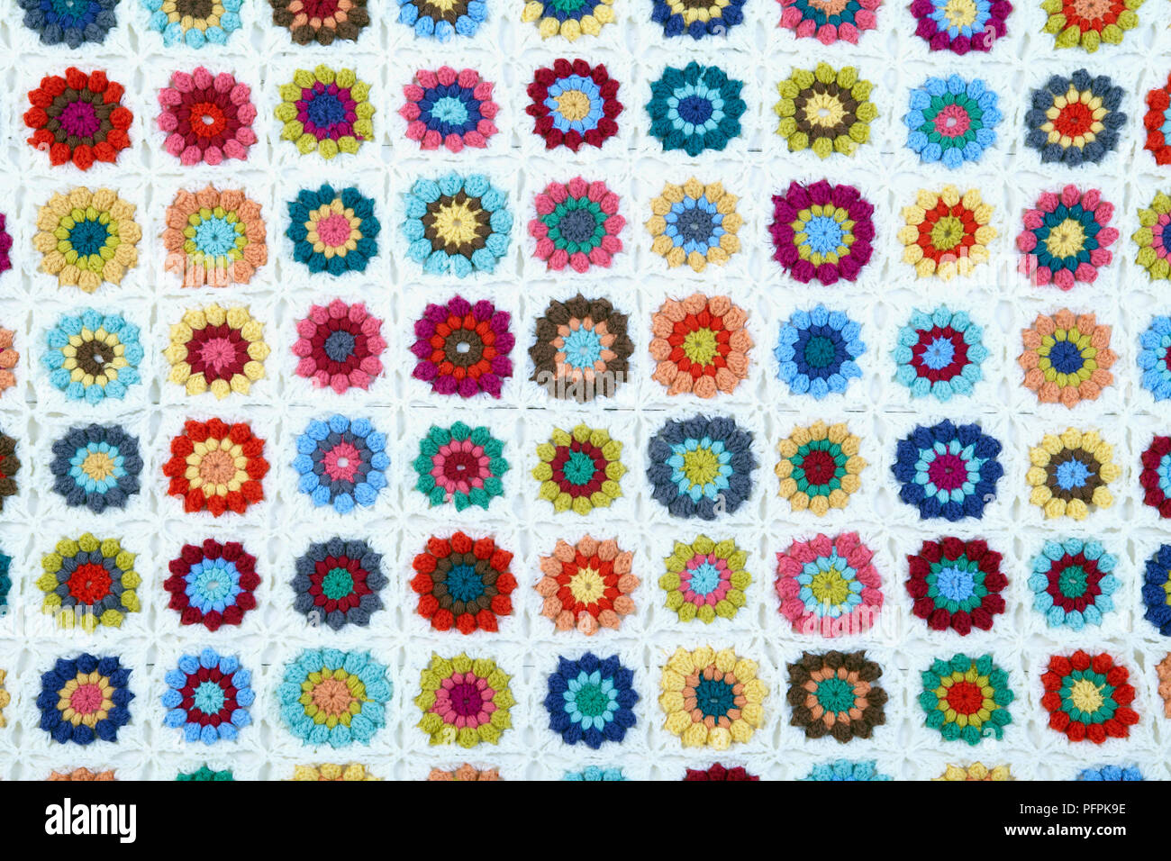 Colourful, crocheted flower-pattern blanket Stock Photo