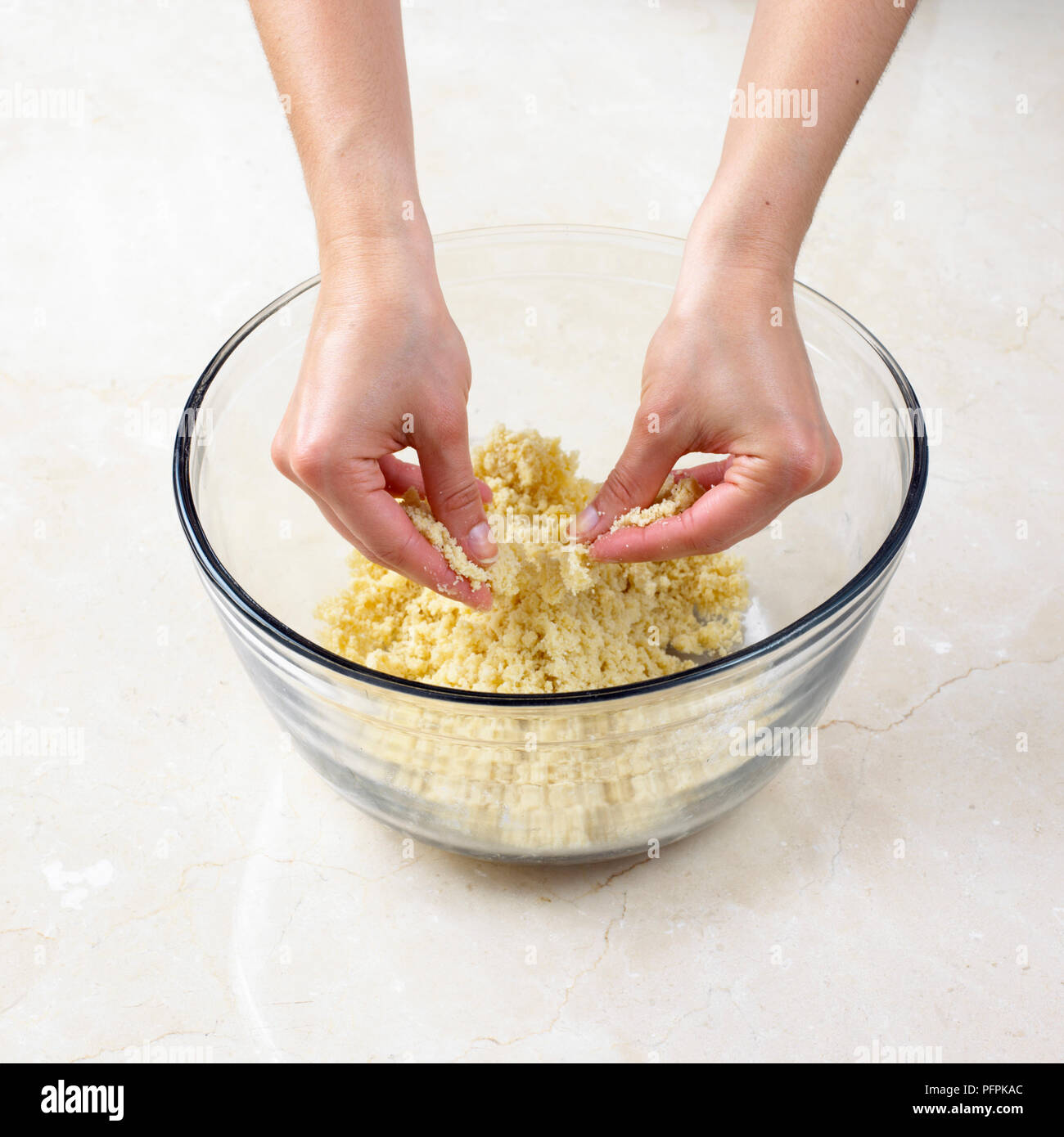 Rubbing butter into flour and sugar mixture, to make sweet crumble