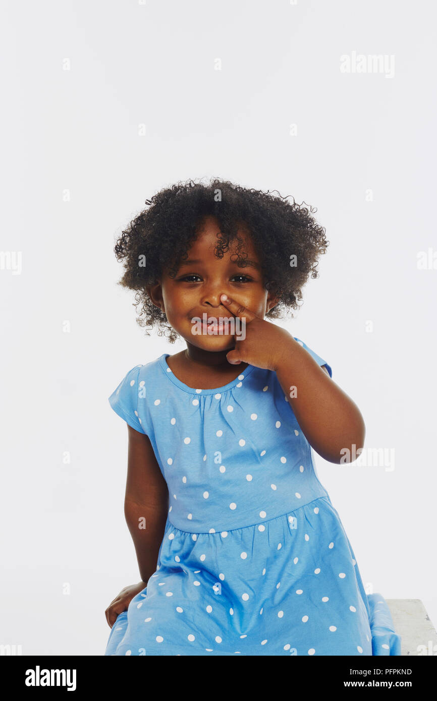 Little girl playing, making faces (Model age - 2 years) Stock Photo