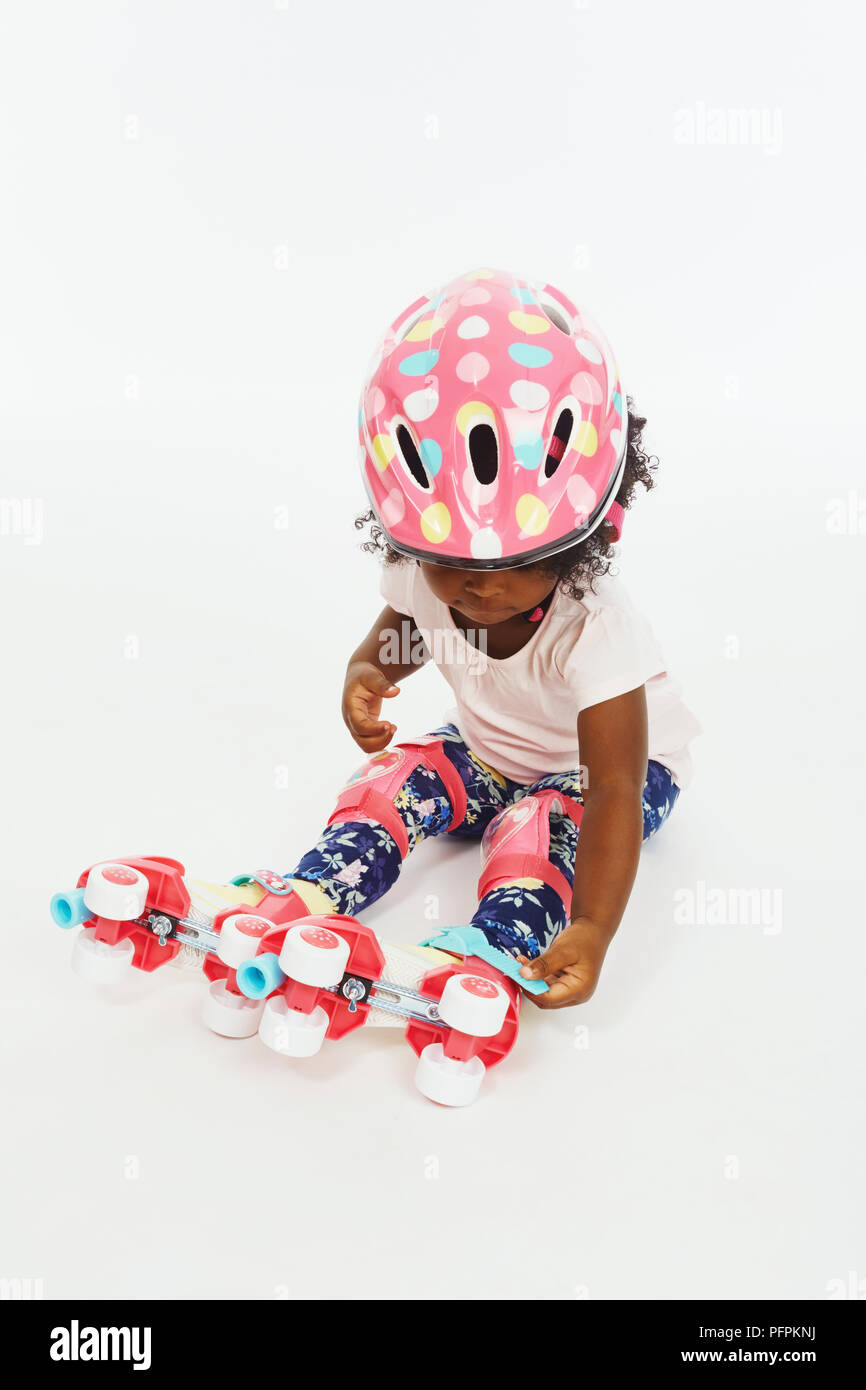 Little girl in roller skates (Model age - 2 years) Stock Photo