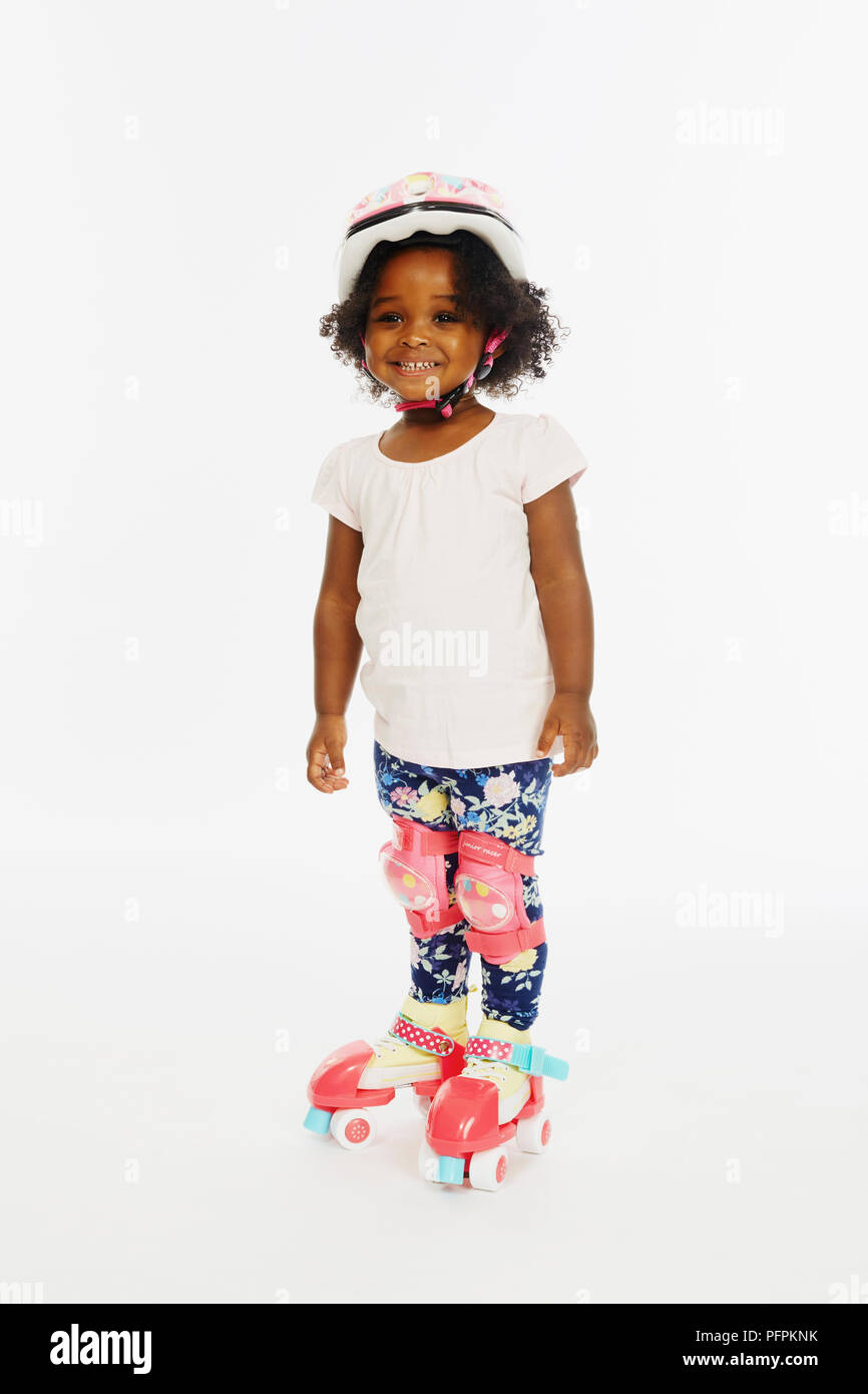 Little girl in roller skates (Model age - 2 years) Stock Photo