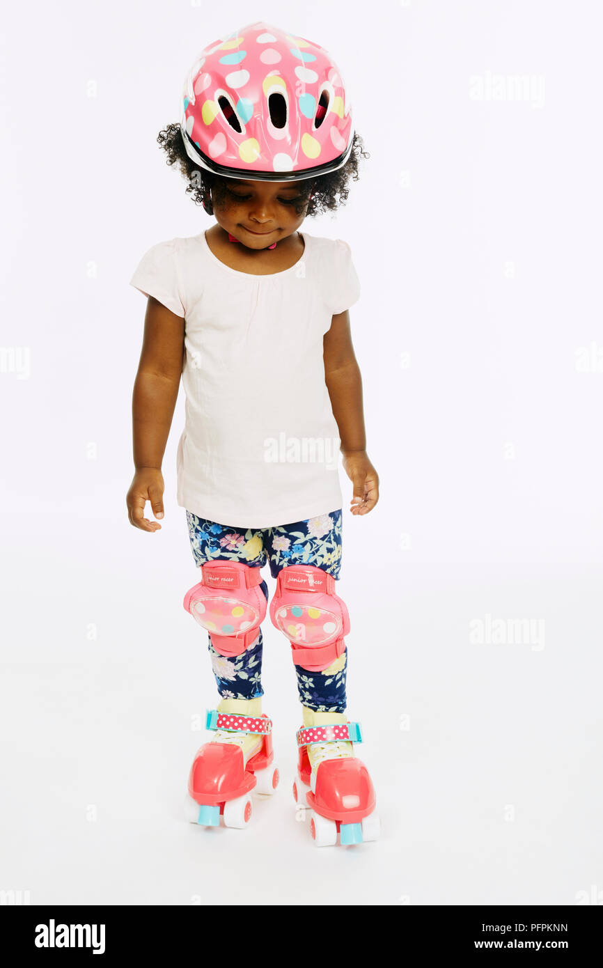 Little girl in roller skates (Model age - 2 years) Stock Photo