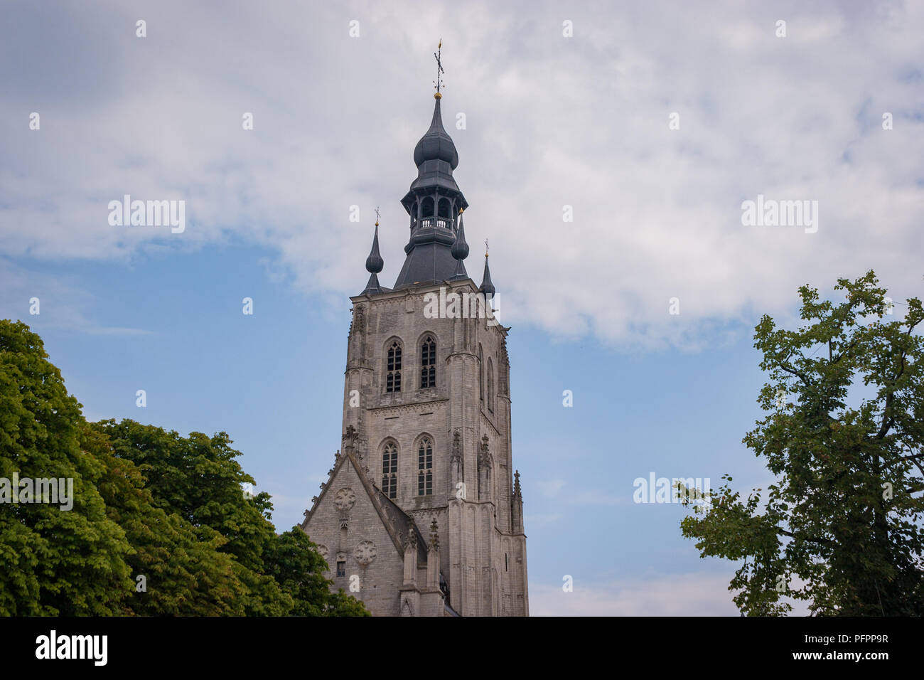 A view of the distinctive onion spire of the Church of Our Lady of the Lake in Tienen, Belgium. Stock Photo