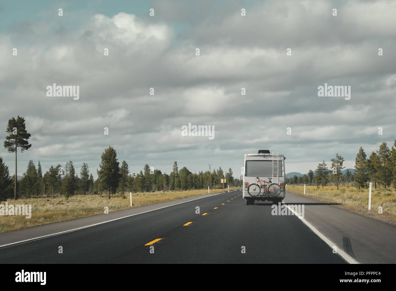 Travel van or RV car or recreatonal vehicle driving on US highway 97 in Oregon, USA. Copy space, travel, road trip, wanderlust concept. Stock Photo