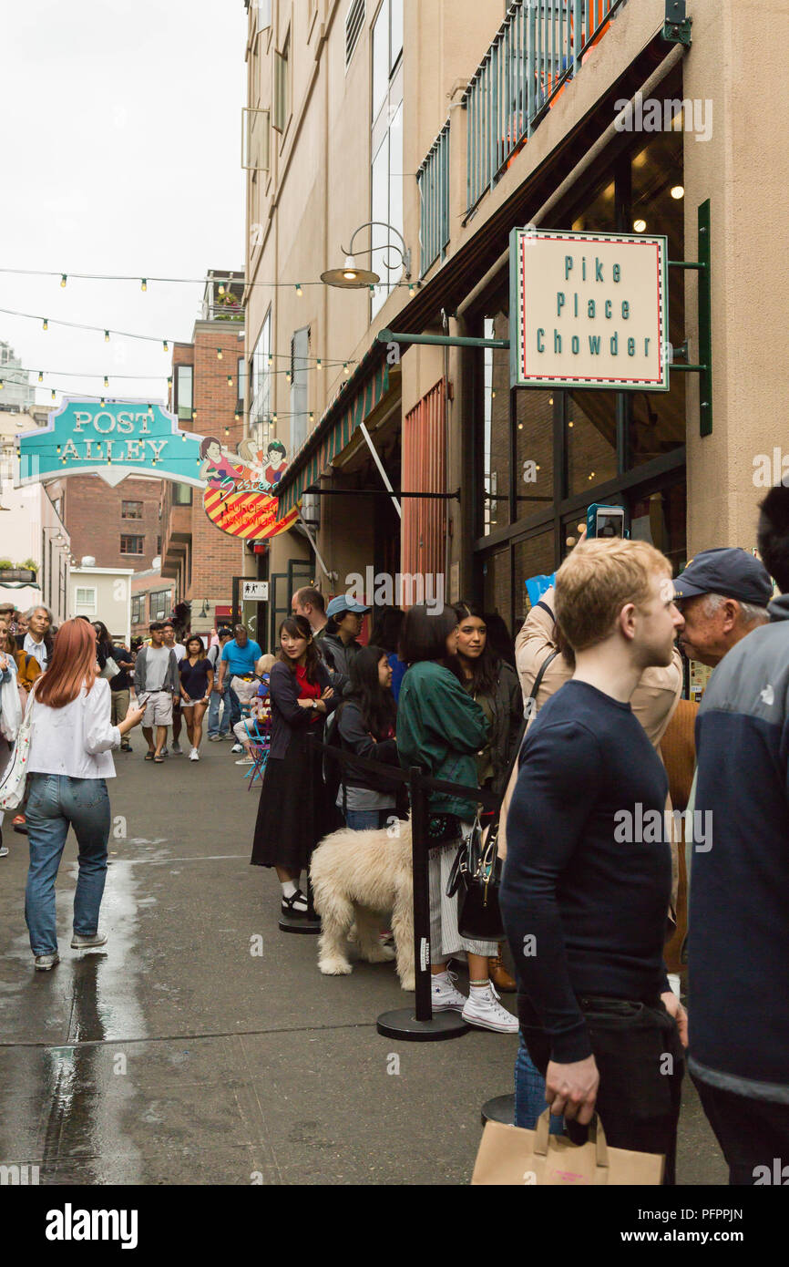 people wait in a long line to taste at the restaurant Pike Place
