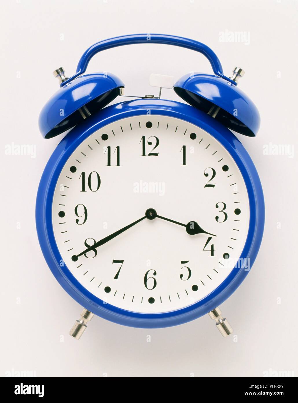 Old fashioned blue alarm clock Stock Photo