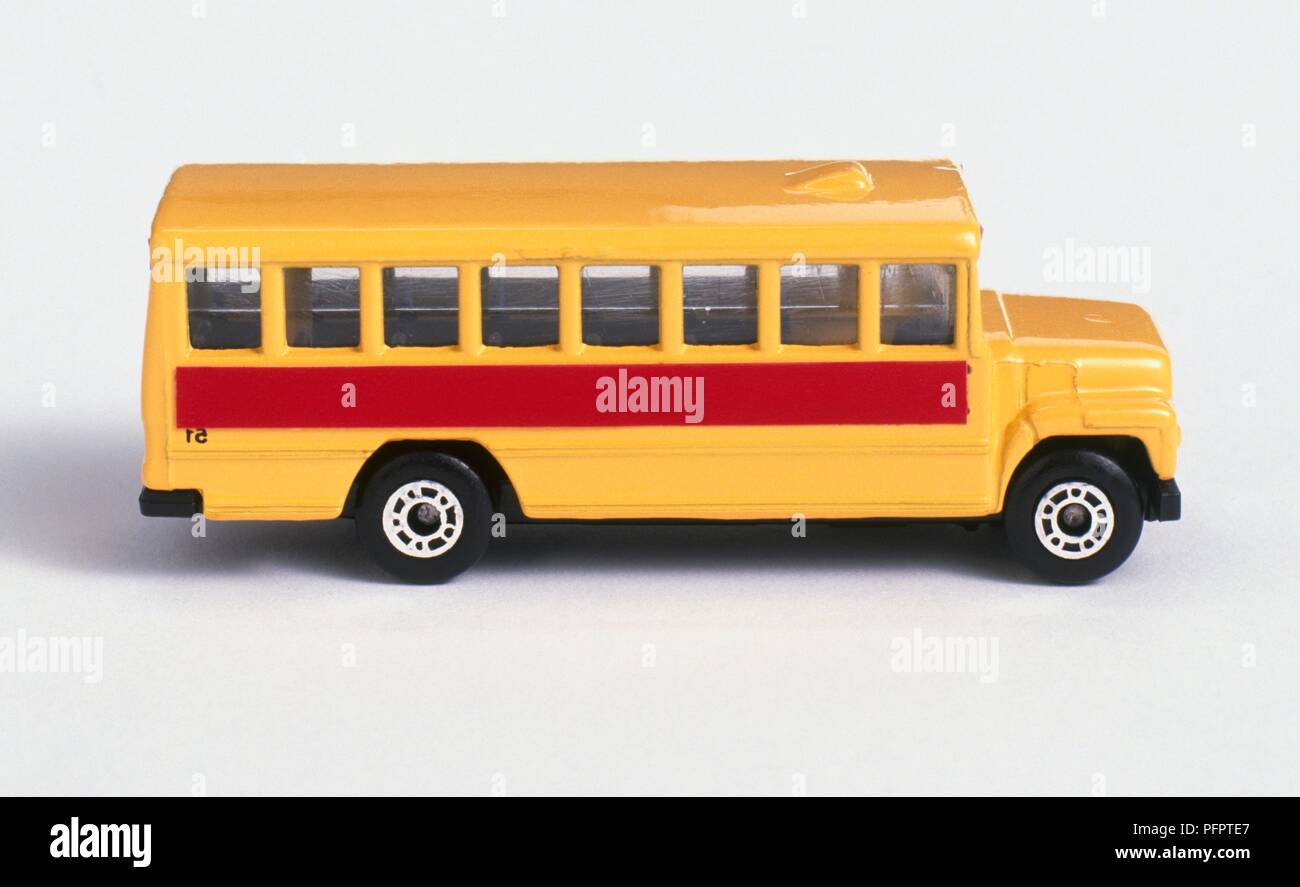 Yellow and red toy school bus Stock Photo - Alamy