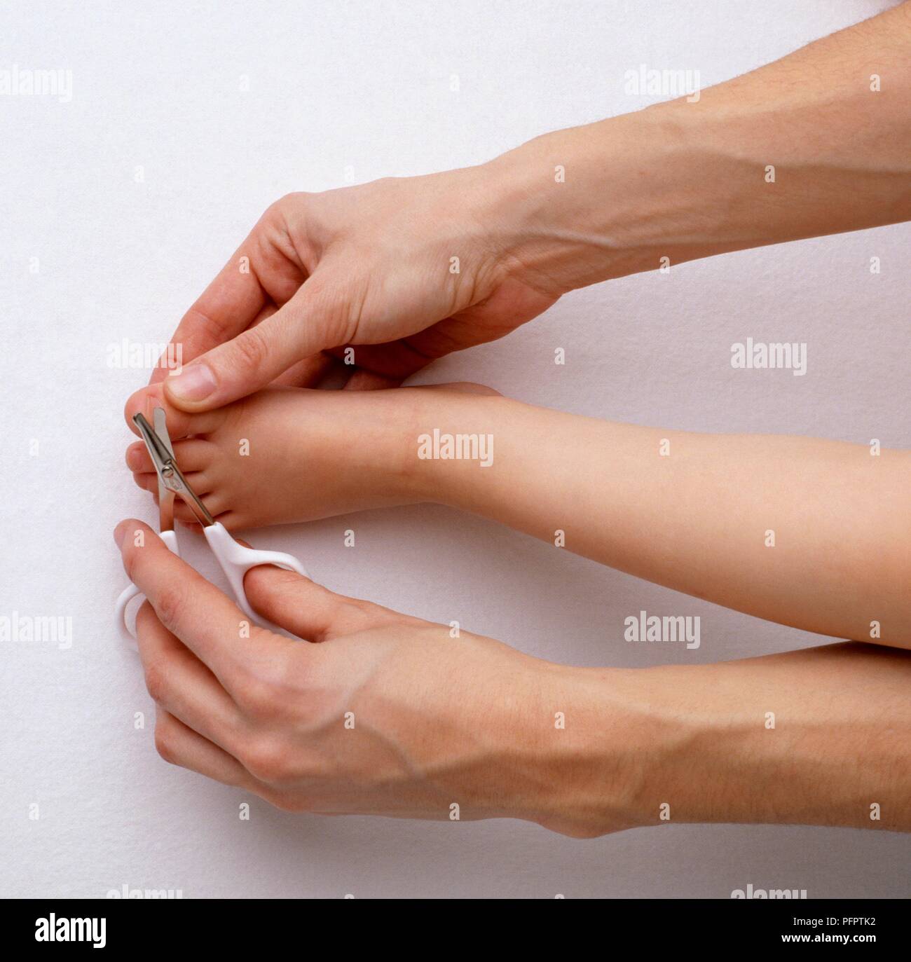 Man cutting the toenails of a preschooler with special scissors, closeup Stock Photo Alamy