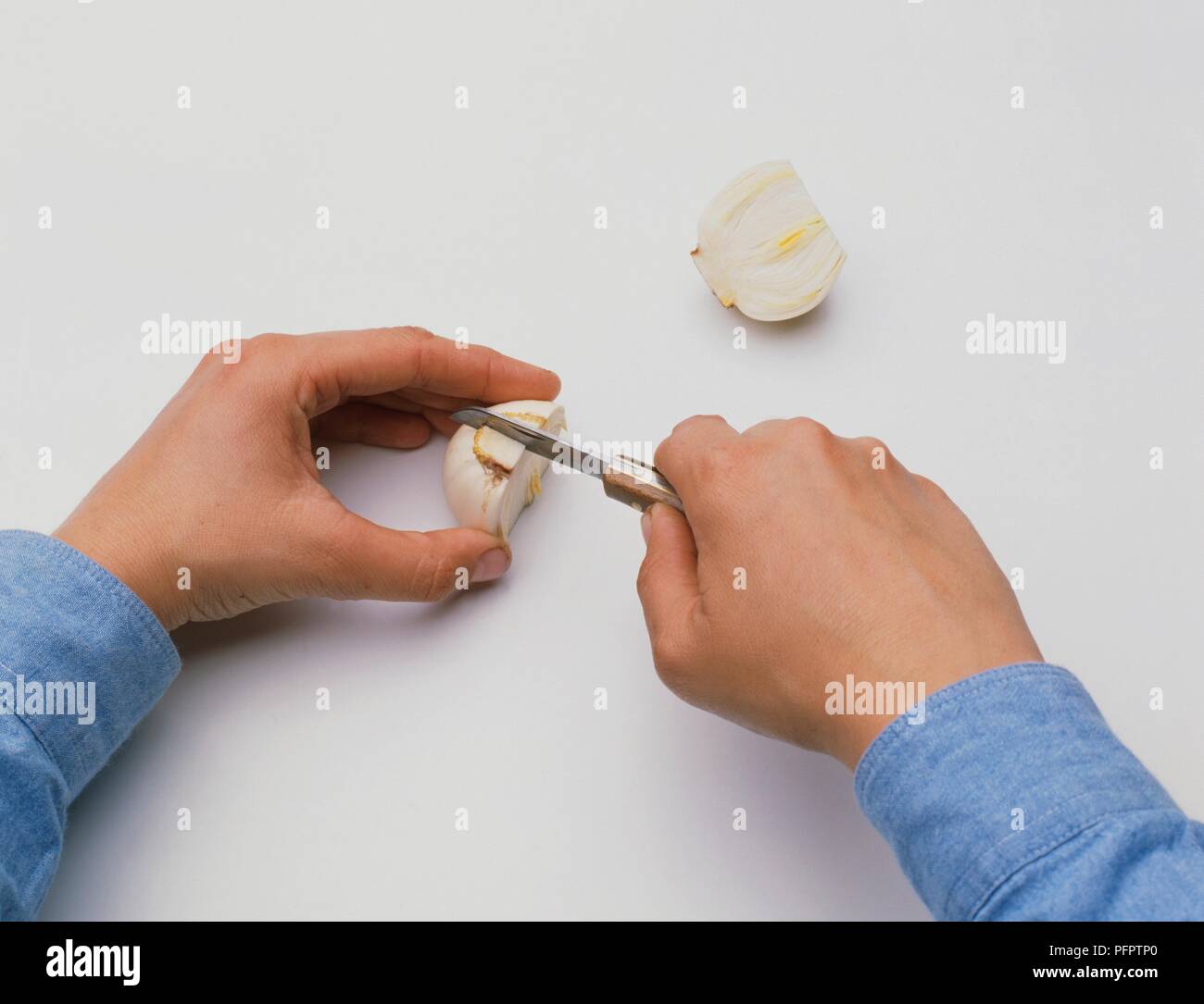 Placing daffodil bulb on its cut end, then cutting downwards through
