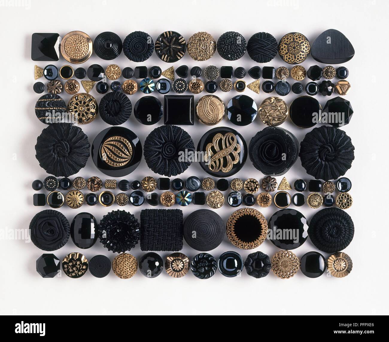 Ornate black and gold buttons of various shapes and sizes Stock Photo