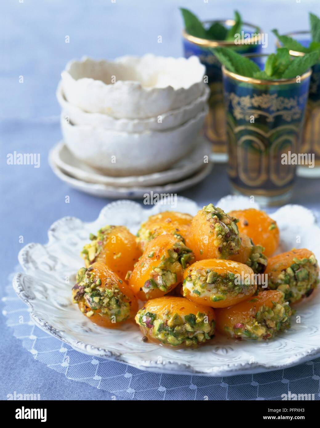 Cardamon and poached apricots with mascarpone and pistachios Stock