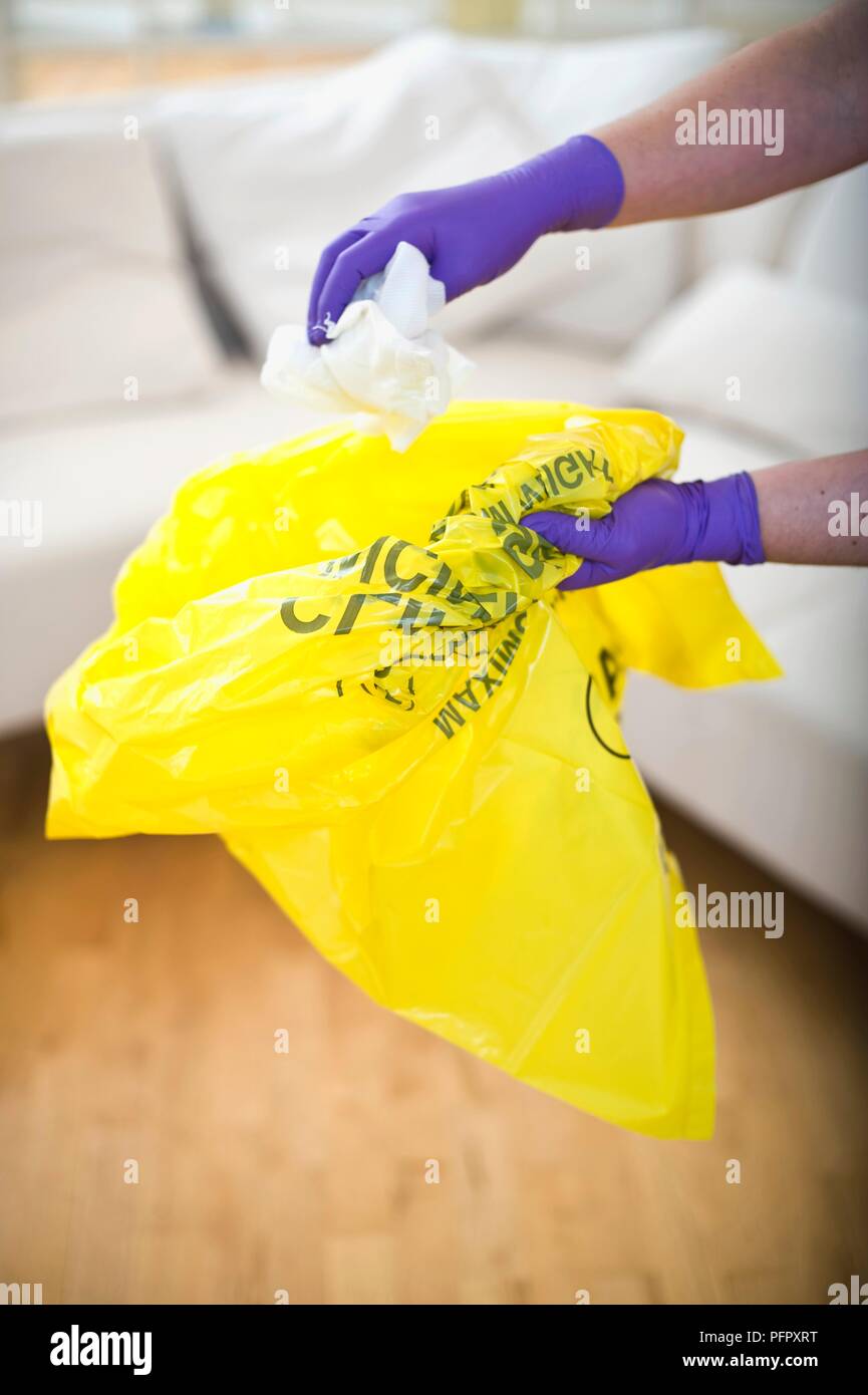 Person wearing latex gloves and disposing gauze in plastic bag, close-up  Stock Photo - Alamy