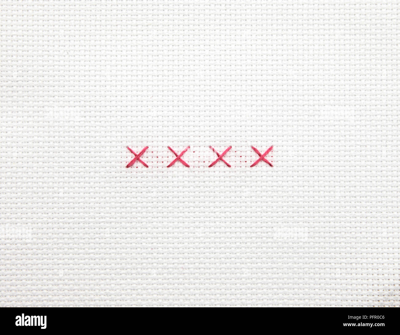 Cross stitches on white fabric Stock Photo Alamy