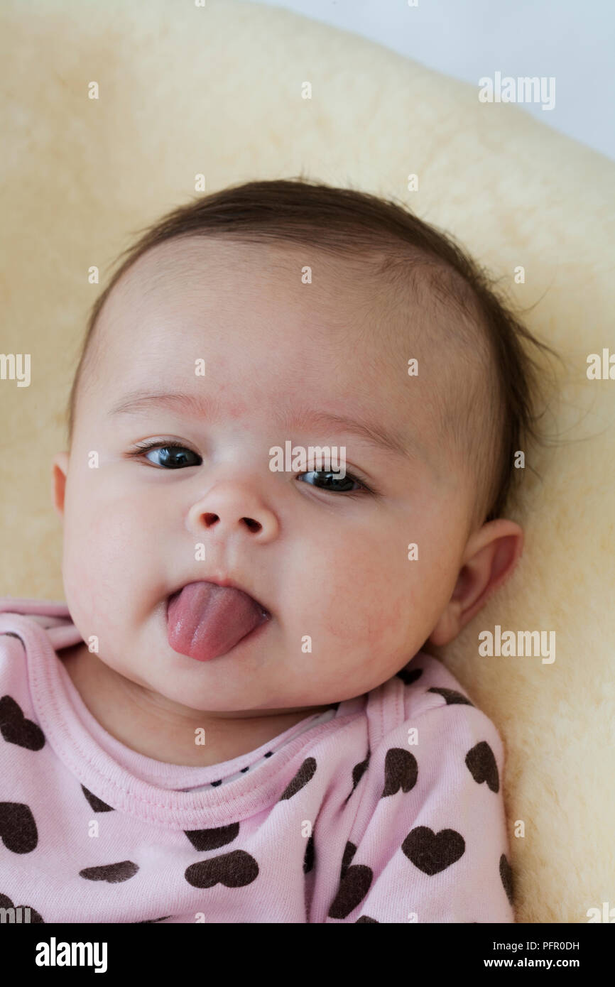 Baby girl sticking out tongue, close-up Stock Photo