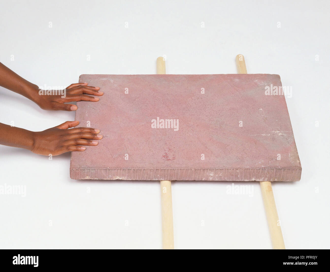 Heavy slab being pushed along on two poles Stock Photo Alamy