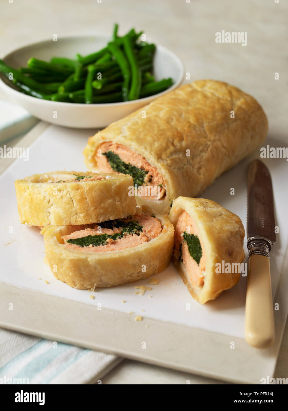 Glutenfree salmon en croute served with green beans Stock Photo Alamy