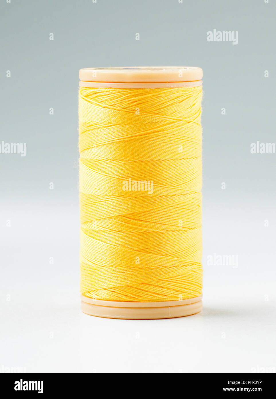 Reel of yellow cotton sewing thread Stock Photo Alamy