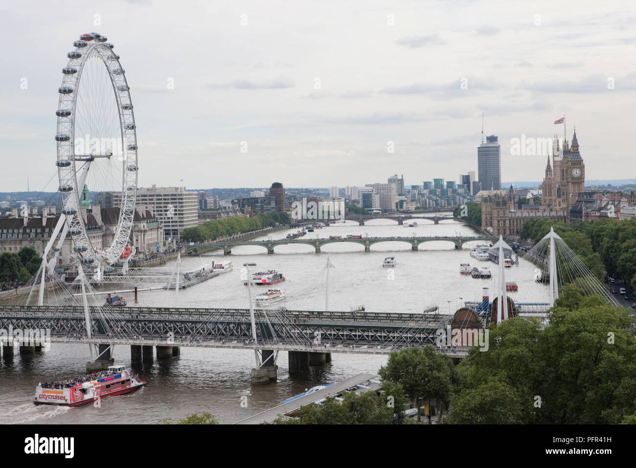 Great Britain, England, London, view of bridges across the Thames with Hungerford Bridge and London Eye in the foreground, Palace of Westminster on the right Stock Photo