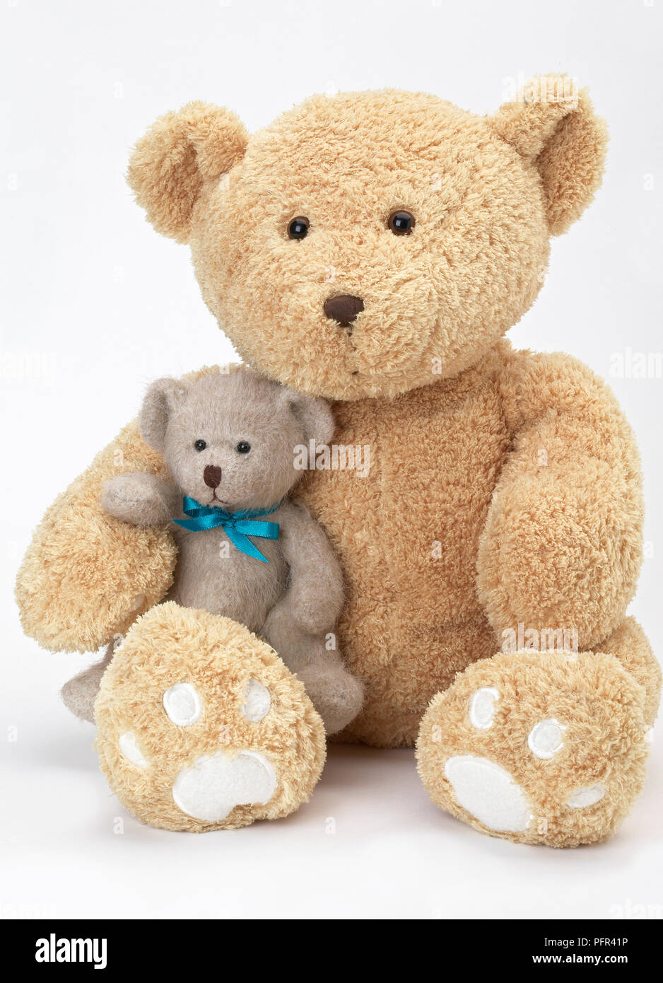 Large teddy bear and baby teddy bear sitting together Stock Photo