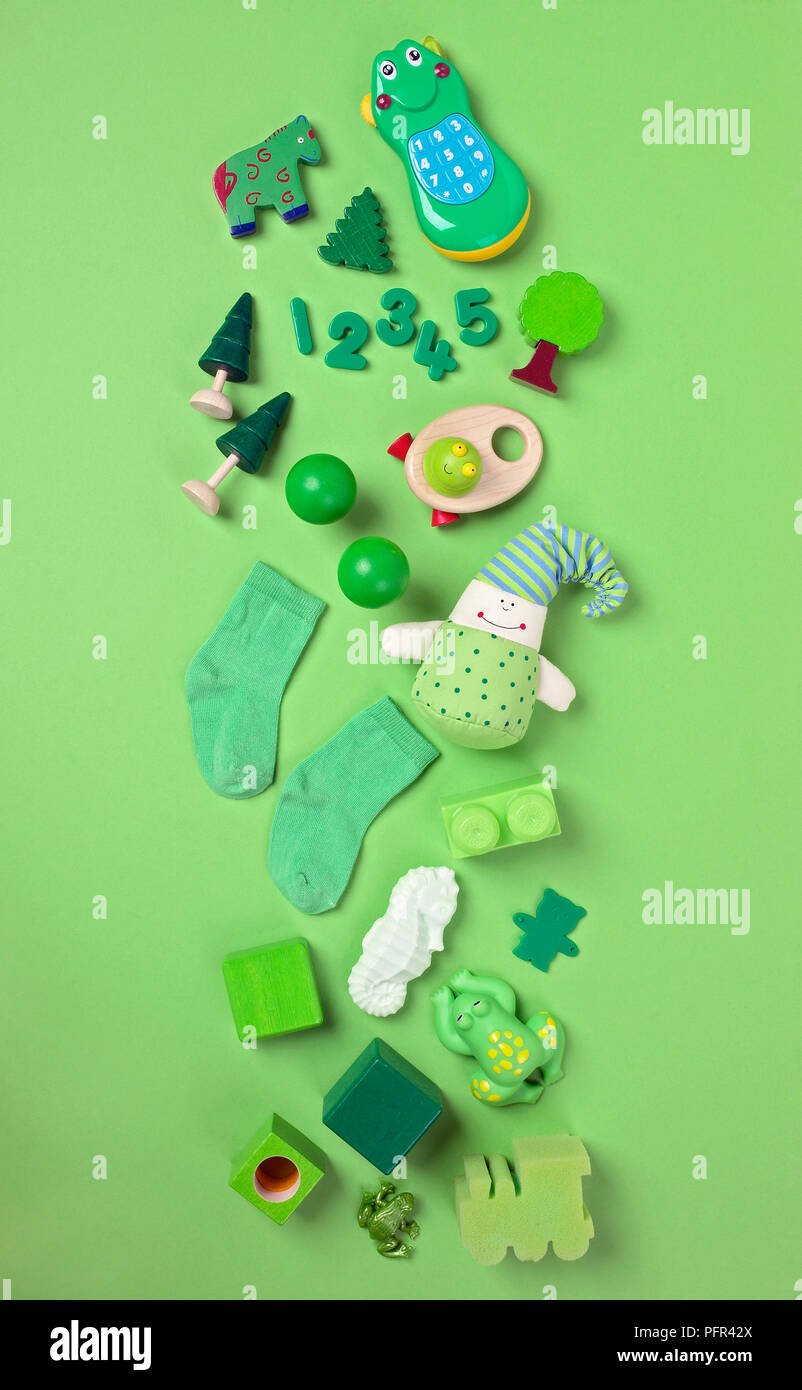 Selection of green toys on green background Stock Photo