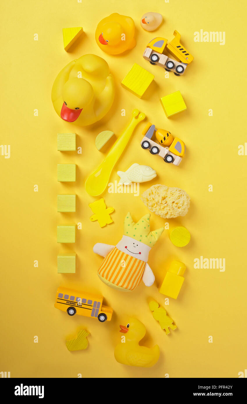 Selection of yellow toys on yellow background Stock Photo