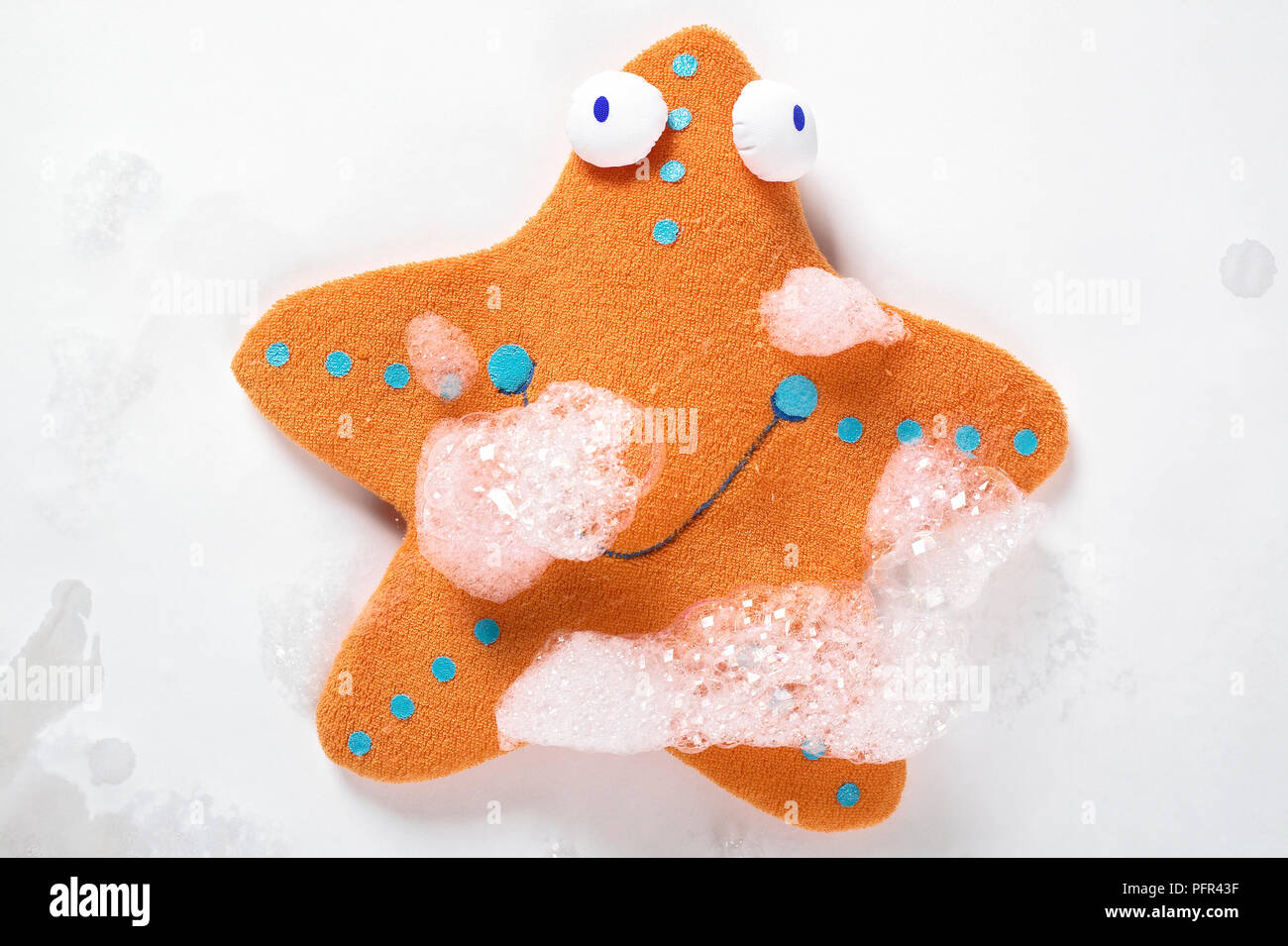 Starfish flannel toy covered in soap suds Stock Photo