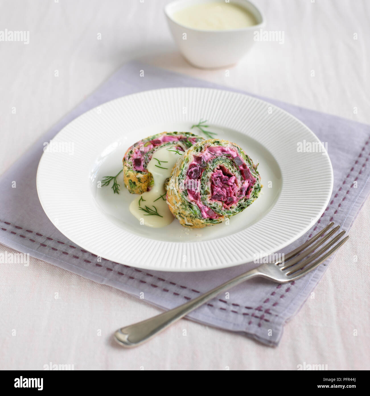 Watercress and beetroot roulade with cheese sauce Stock Photo - Alamy