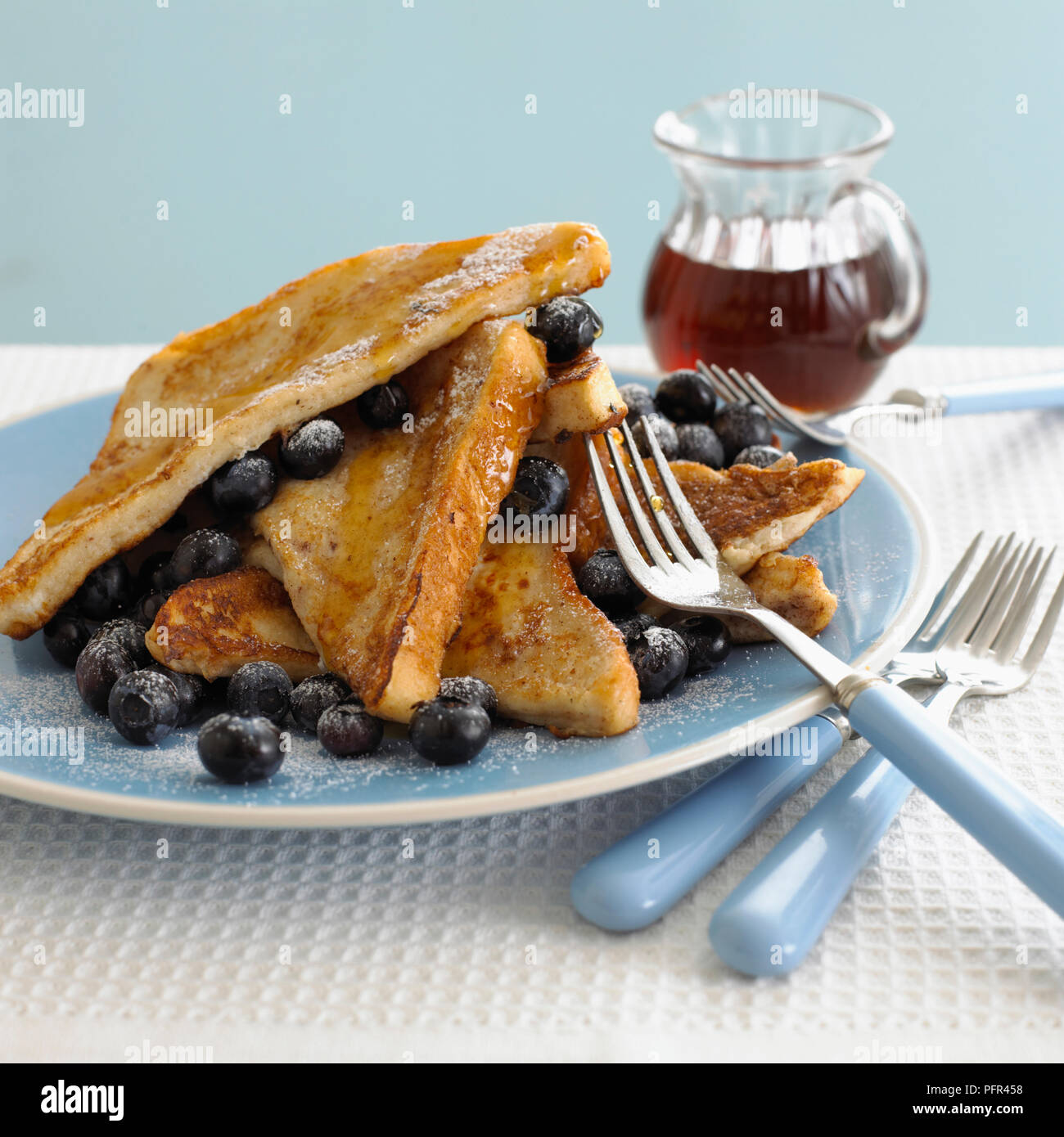 Plate of eggy bread, blueberries and syrup Stock Photo