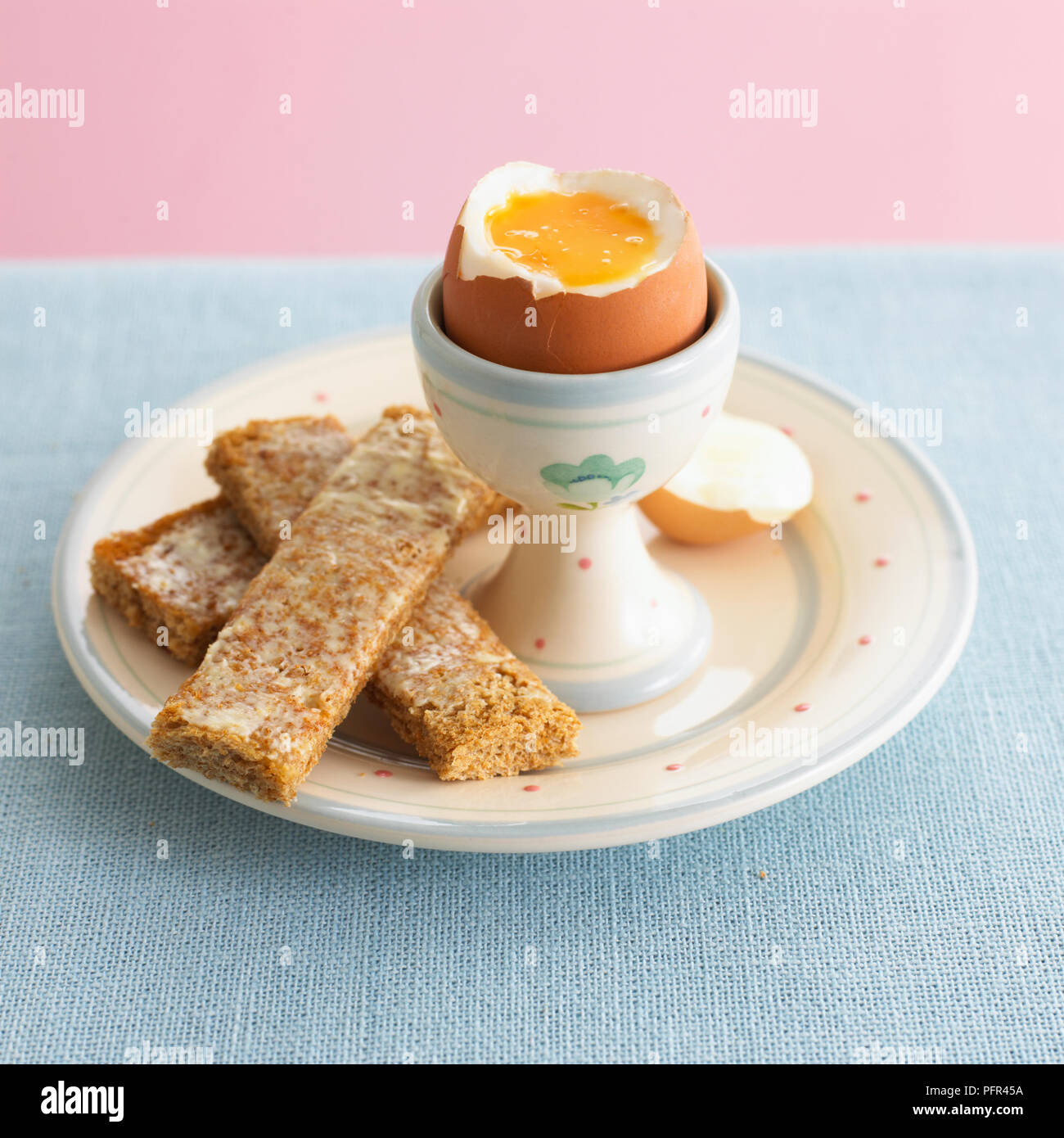 Boiled egg and sliced buttered toast Stock Photo