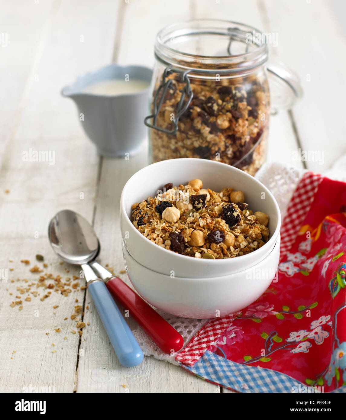 Sealed jar and bowl of fruity breakfast cereal Stock Photo