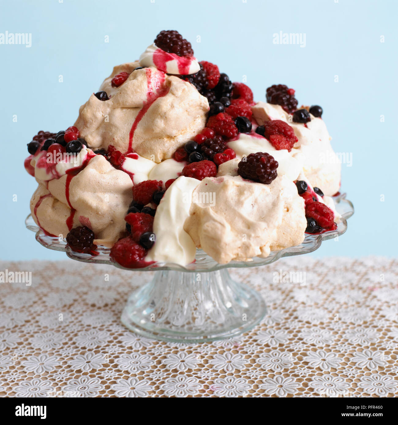 Tower of meringues with berries and cream Stock Photo