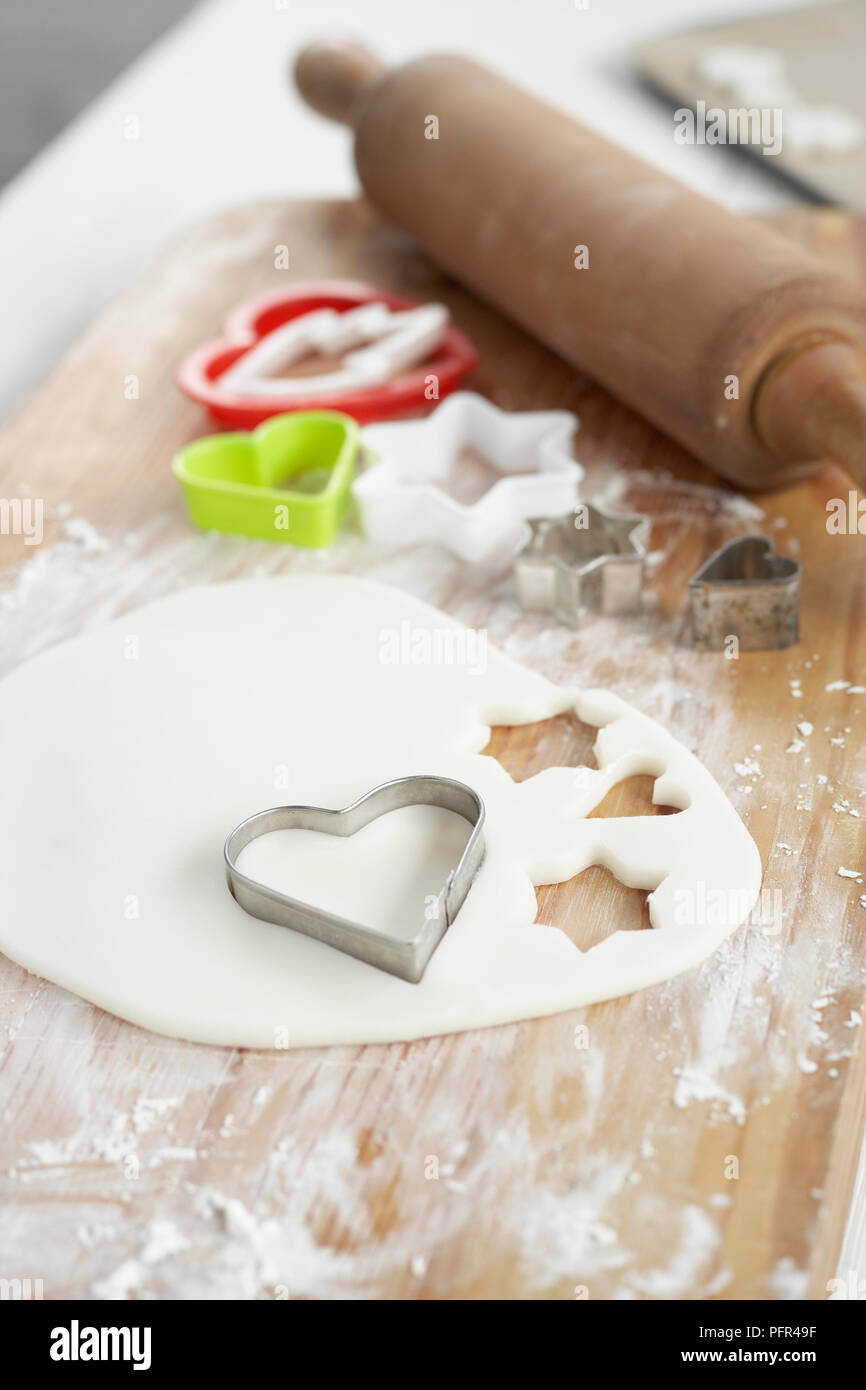Heart shape biscuit cutter on gingerbread dough Stock Photo