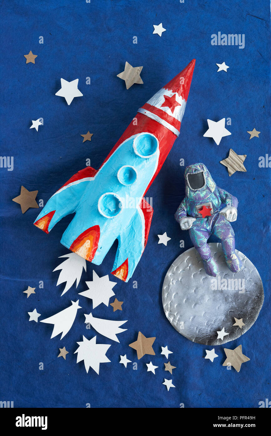 Papier-mache rocket (pen pot) and astronaut Stock Photo