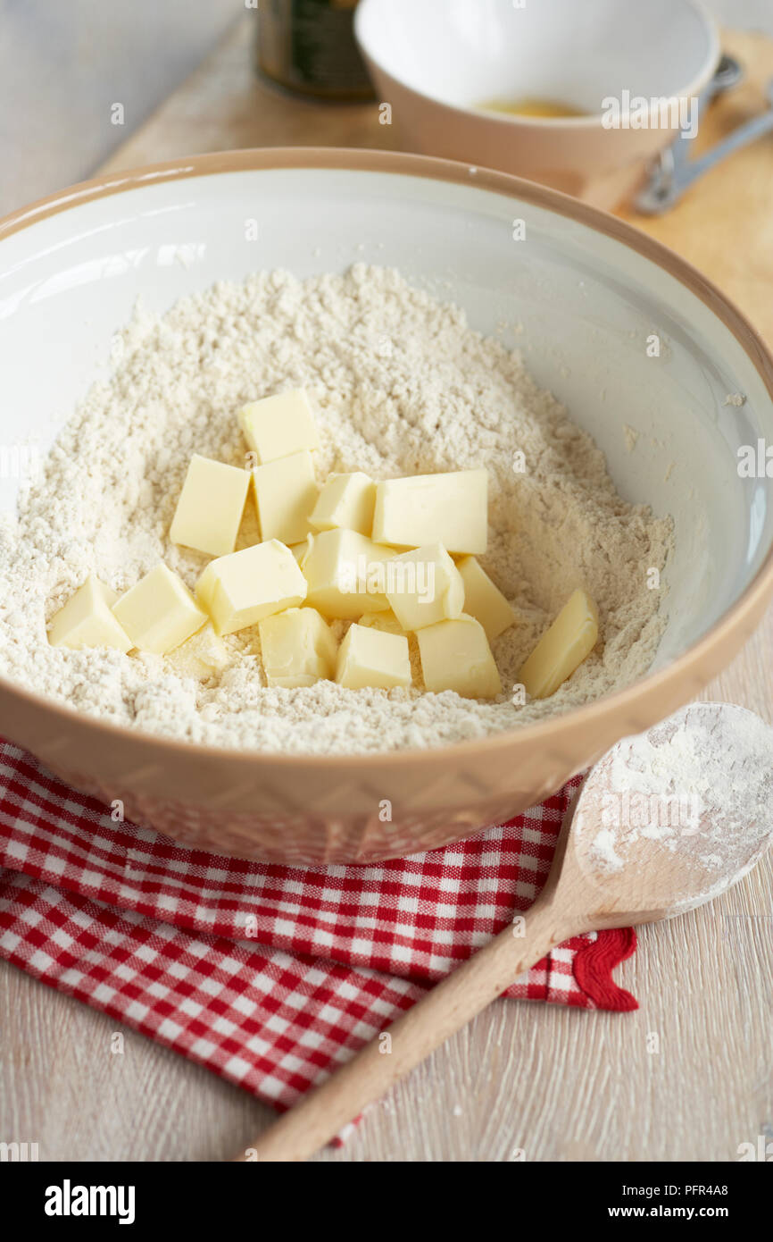 Flour and butter cubes in mixing bowl, to make biscuit dough Stock Photo