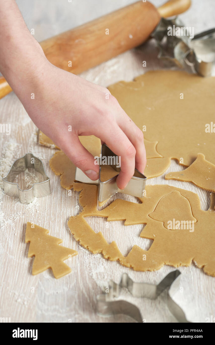 Cutting biscuit shapes from dough Stock Photo
