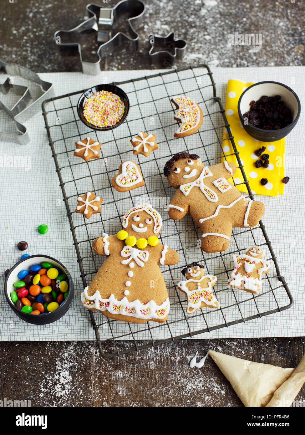 Gingerbread men and shapes with icing on cooling rack Stock Photo