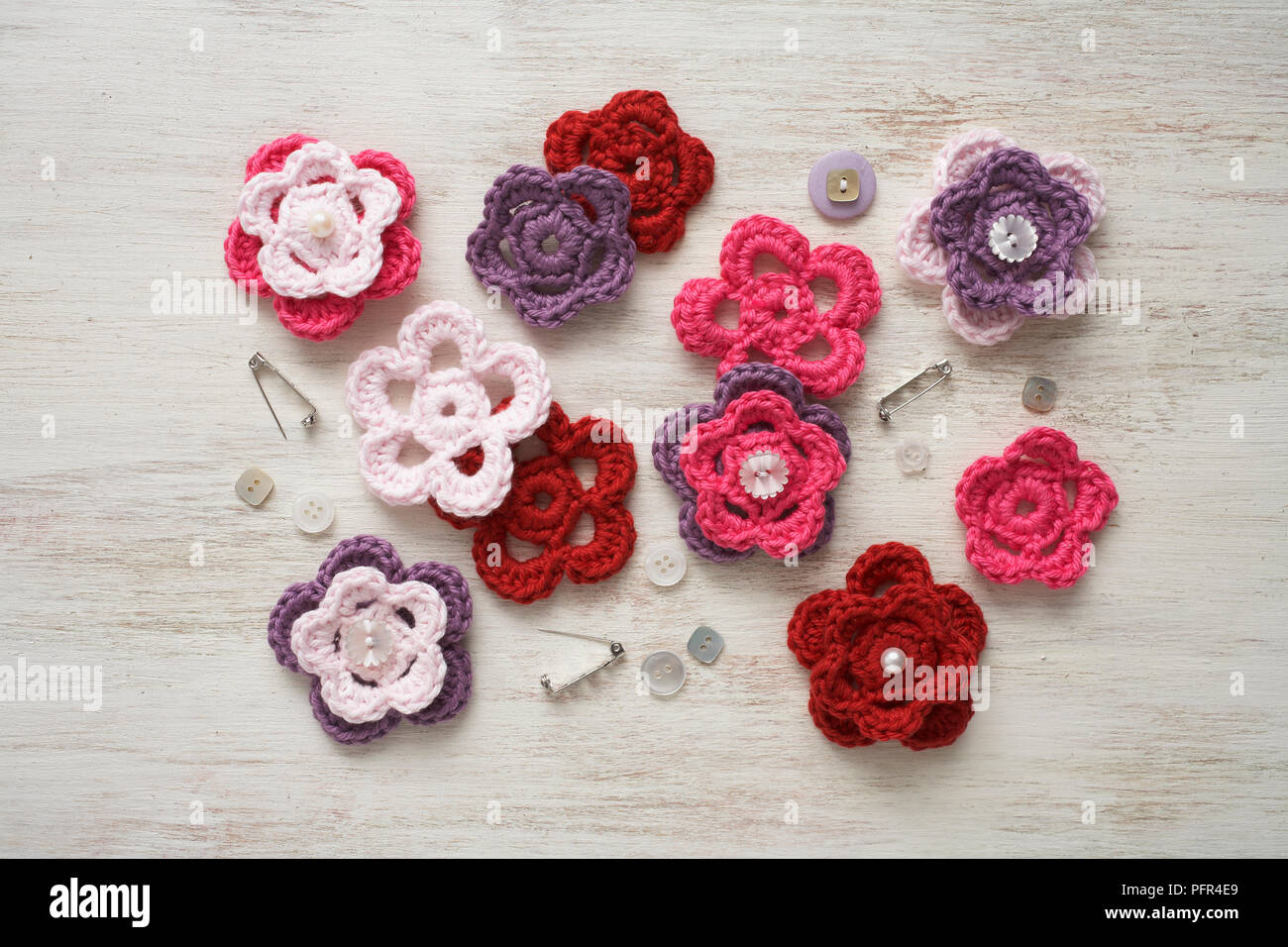 Materials for hand-made crochet flower brooches Stock Photo
