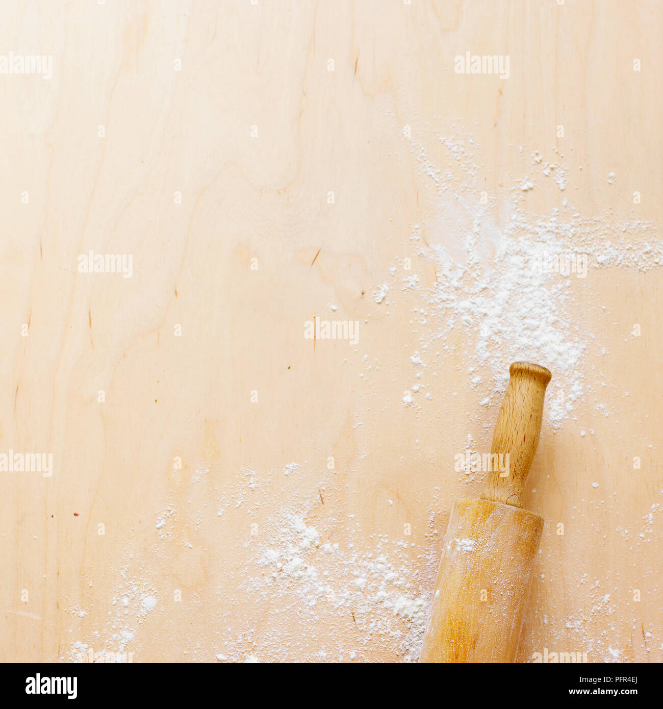 Rolling pin on floured surface Stock Photo