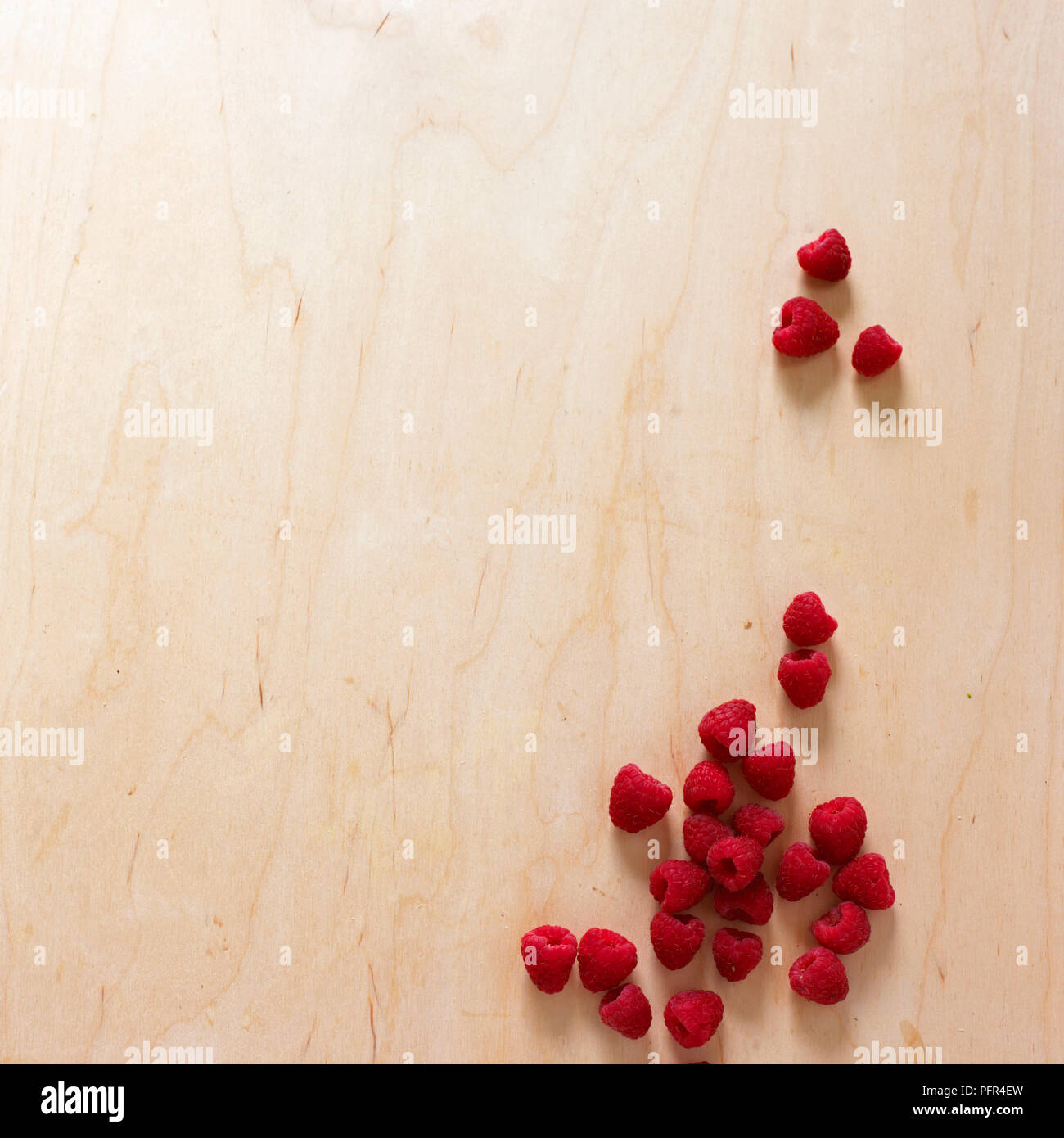 Fresh raspberries on wooden surface Stock Photo