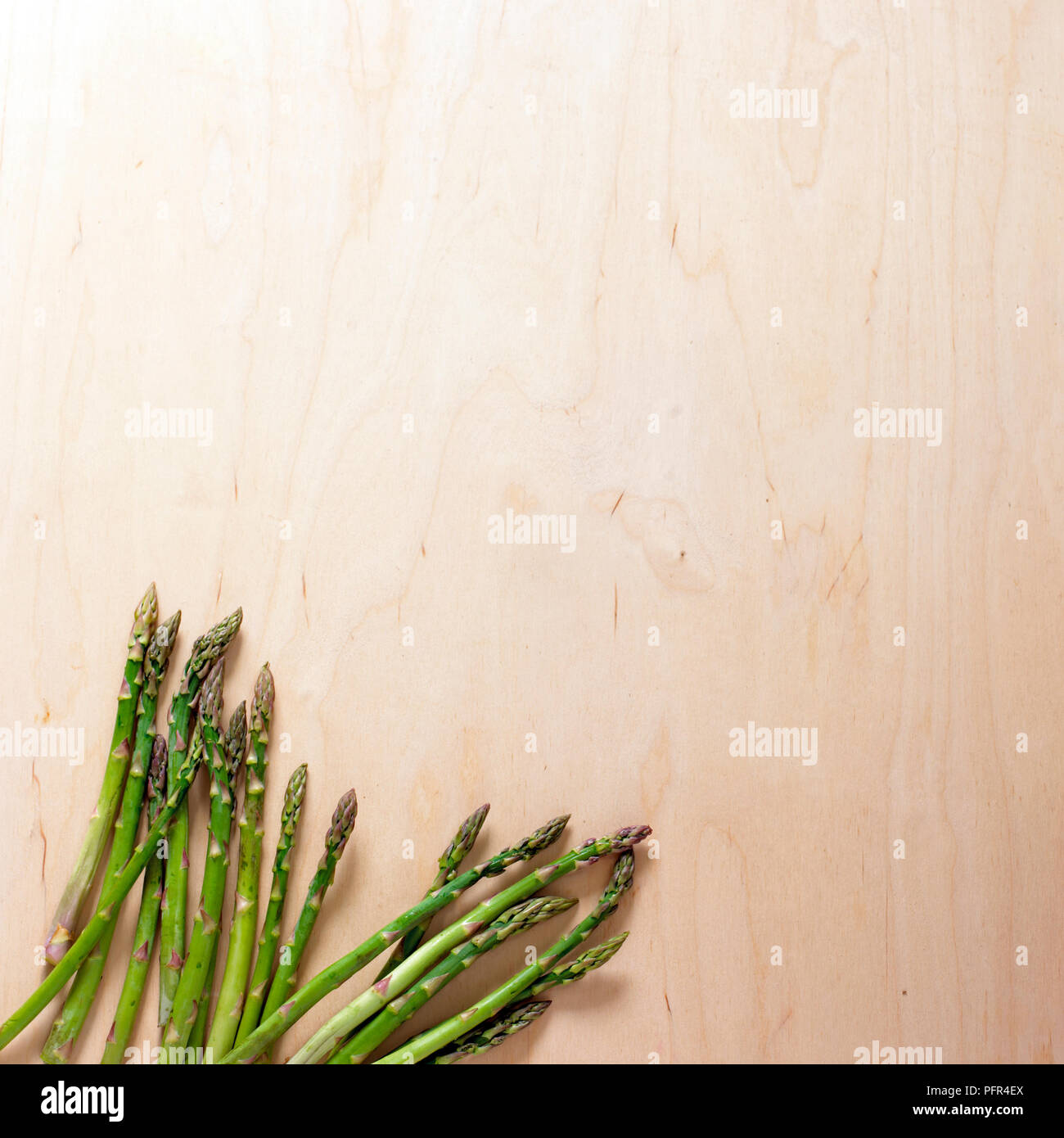 Green asparagus on wooden surface Stock Photo