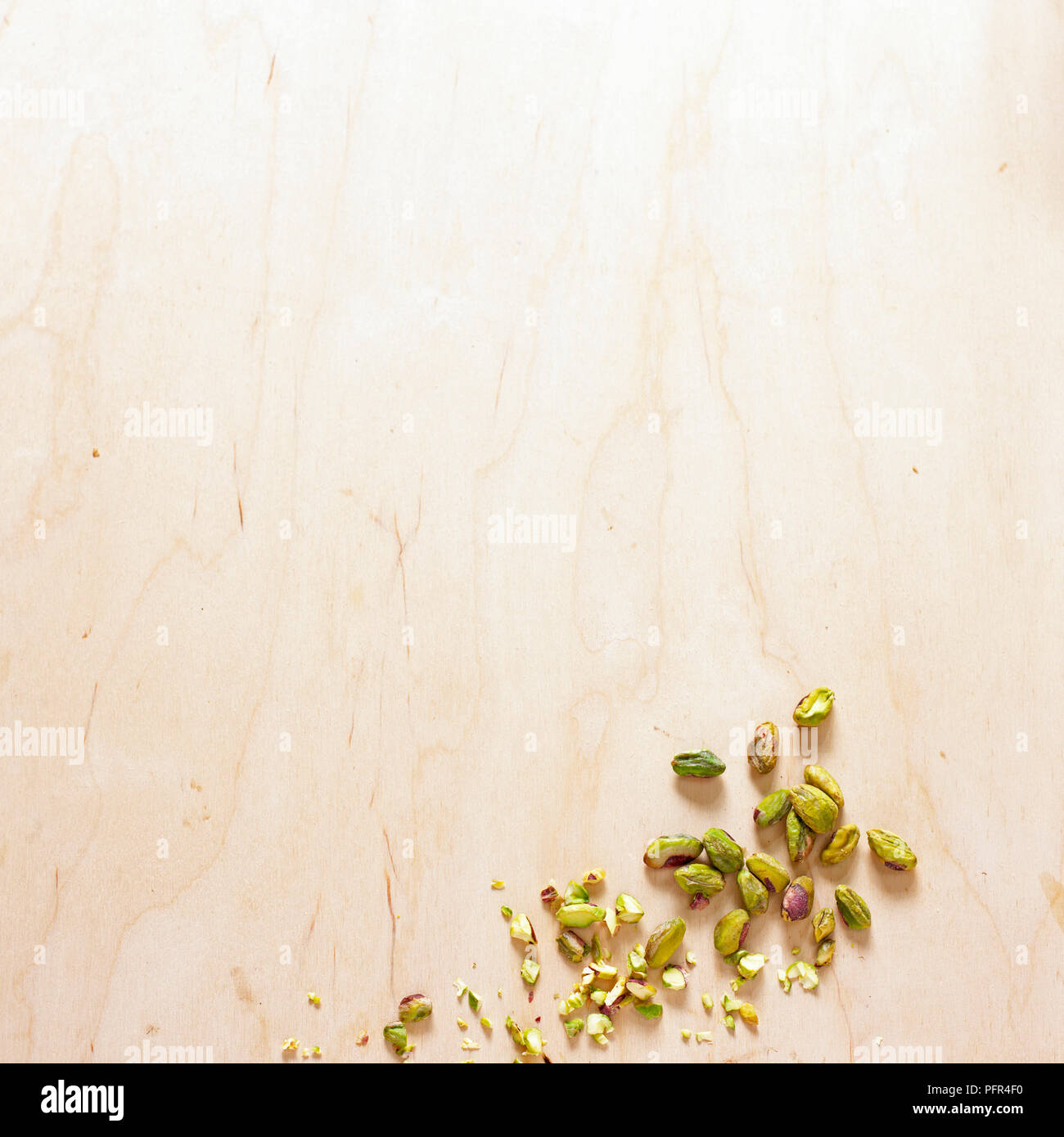 Pistachio nuts on wooden surface Stock Photo