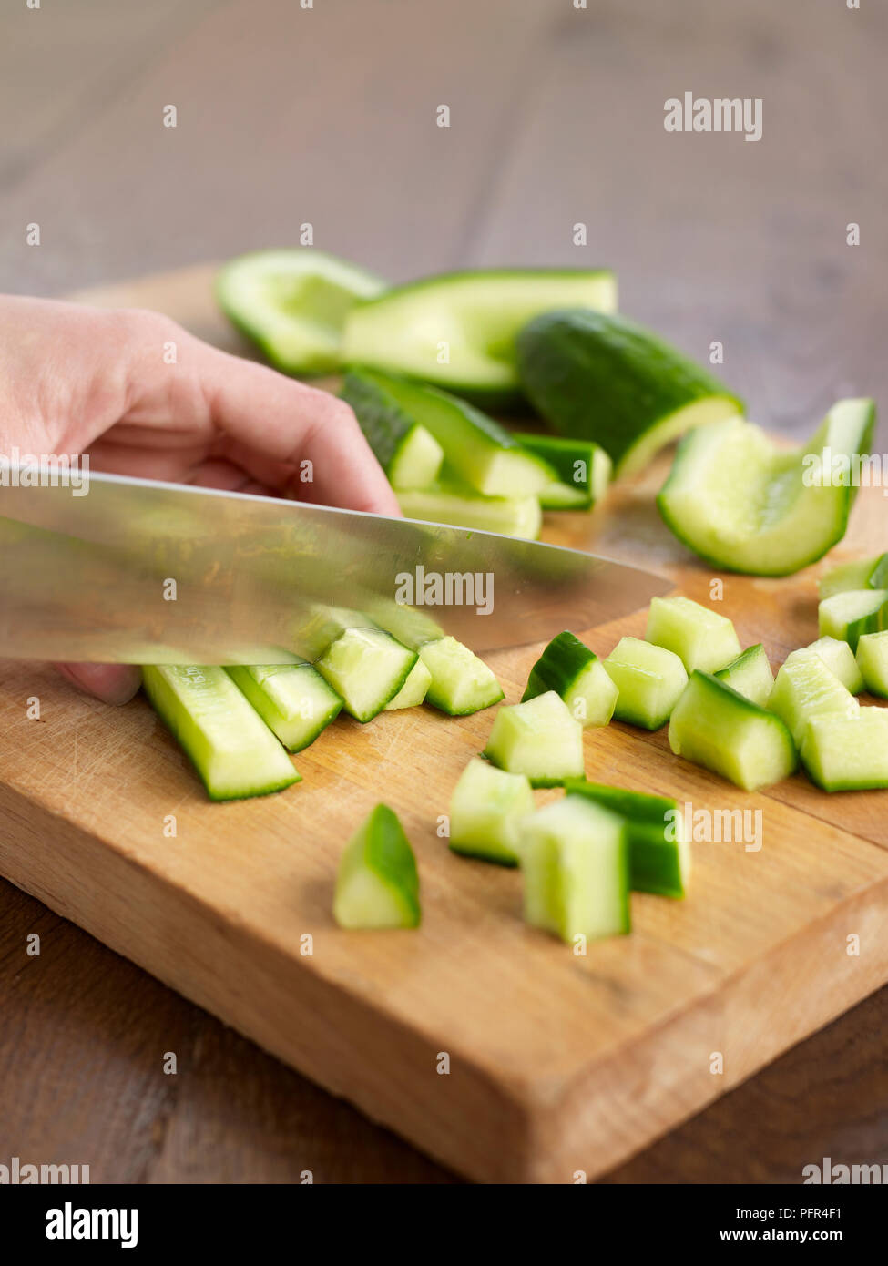 Chopping cucumbers Stock Photo