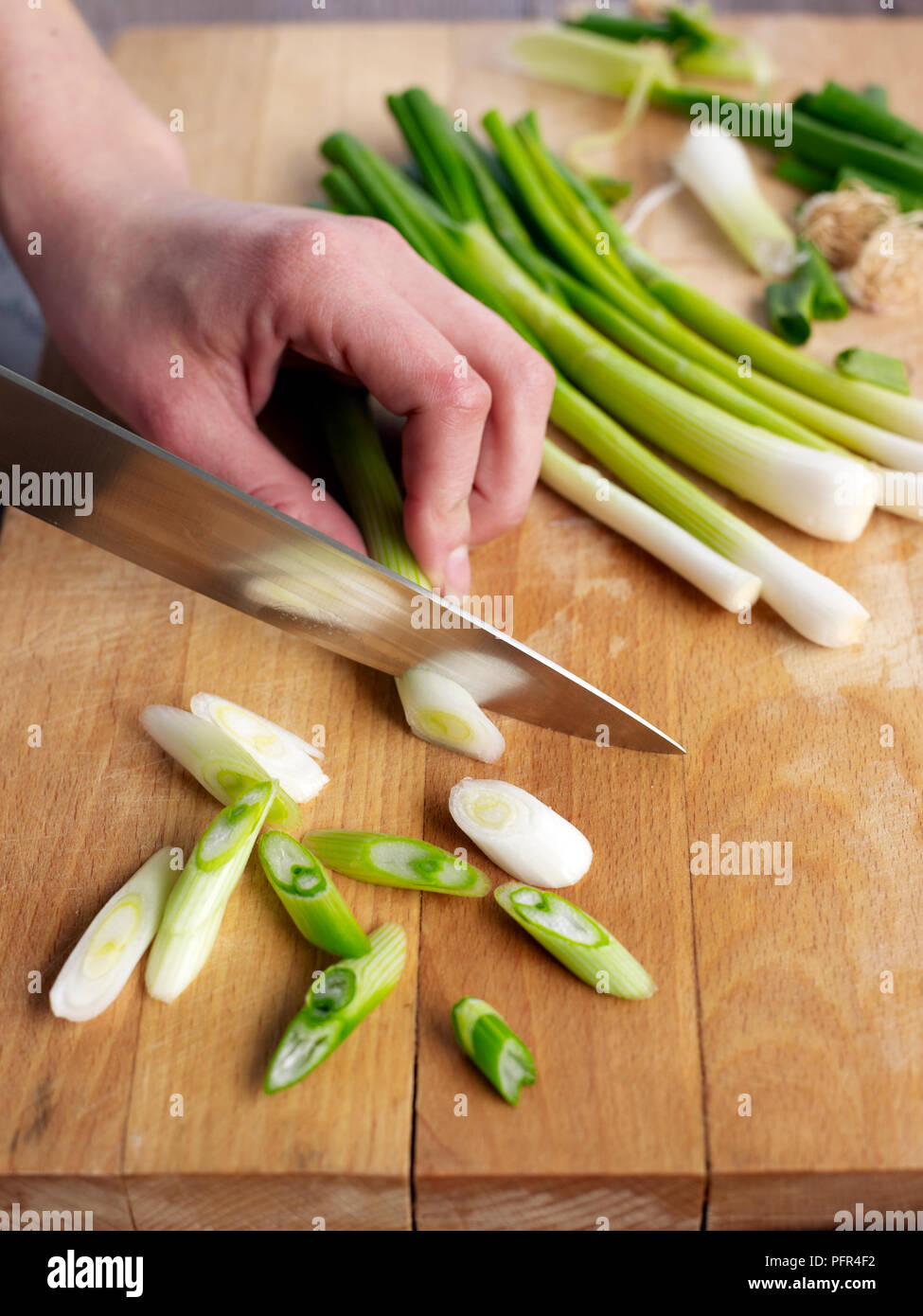 Chopping spring onions Stock Photo
