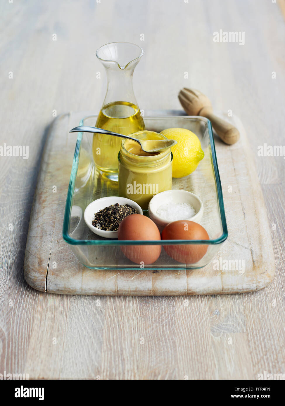 Ingredients for making mayonnaise sauce, wood background Stock Photo