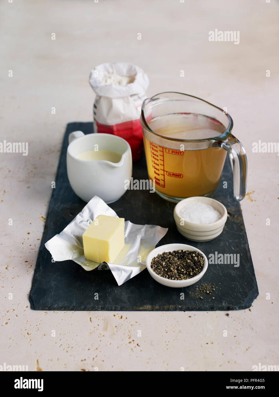 Ingredients for cooking veloute sauce, flour, chicken or veal stock, double cream, butter, salt, pepper Stock Photo