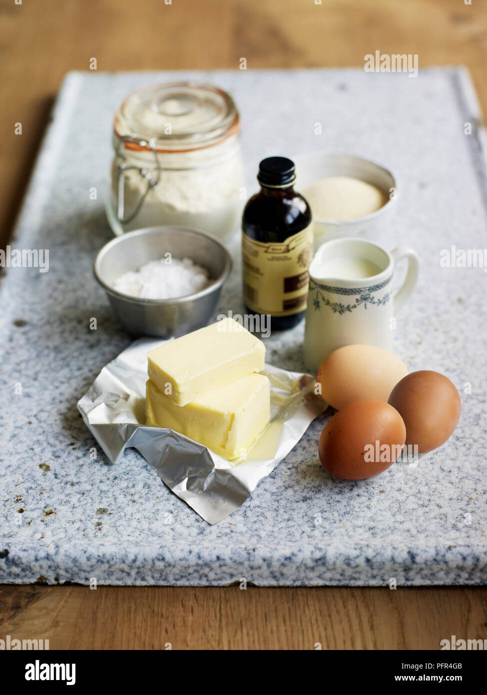Ingredients for Victoria sponge cake, flour, vanilla extract, sugar, icing sugar, eggs, milk, butter Stock Photo