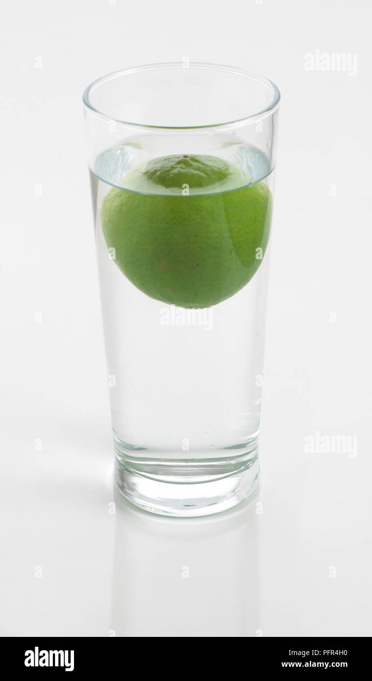 Lime floating in glass of water Stock Photo Alamy