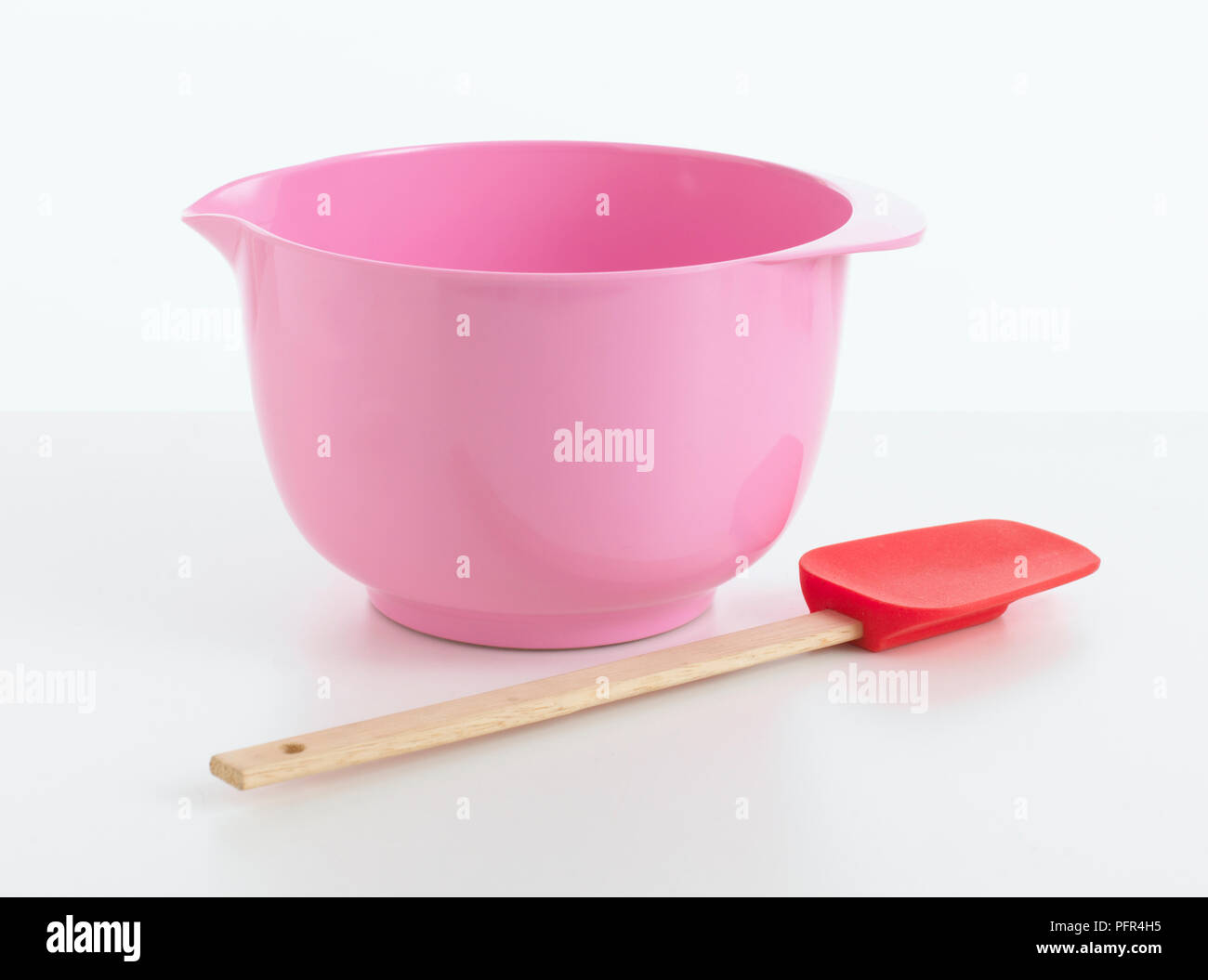 Pink mixing bowl and cake spatula Stock Photo
